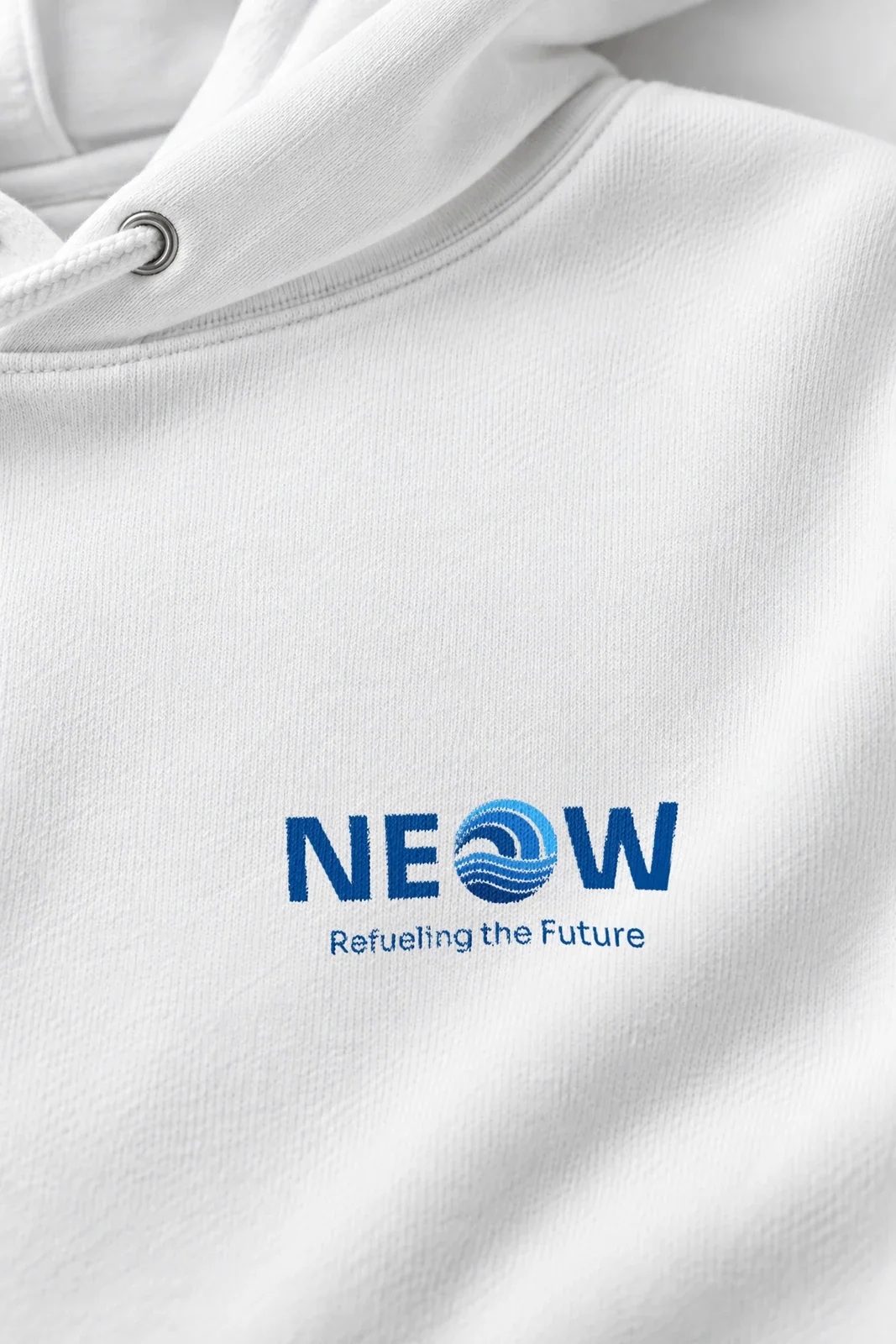 Unisex essential eco hoodie, close-up of the blue NEOW lockup with Refueling the Future printed on the white fleece below the hood eyelet